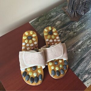 New Massage sandals with stones on a wooden platform. Massage the  nerve endings